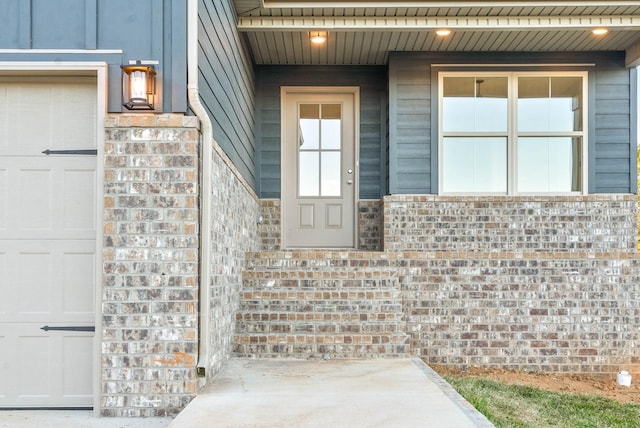 doorway to property with brick siding