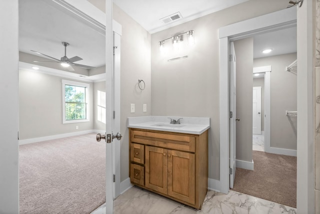 bathroom with vanity, a ceiling fan, baseboards, visible vents, and marble finish floor