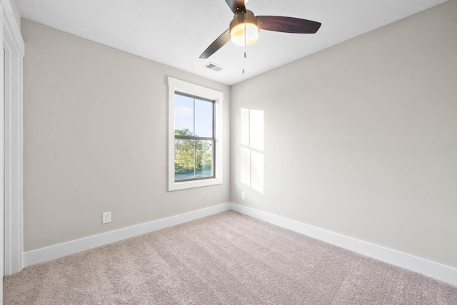 spare room featuring visible vents, baseboards, a ceiling fan, and carpet flooring