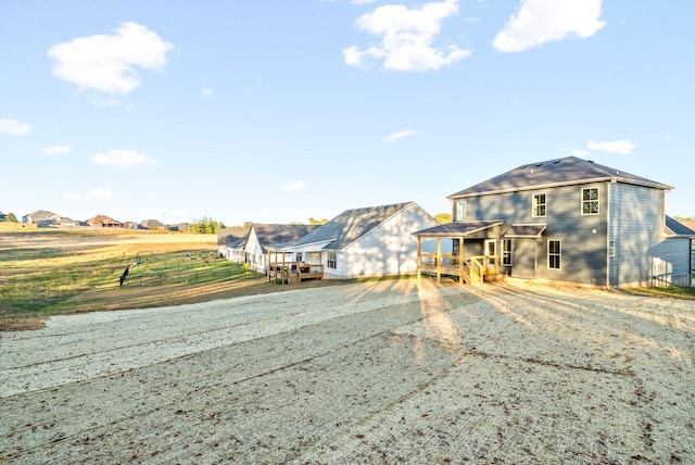 view of front of property featuring a deck and fence