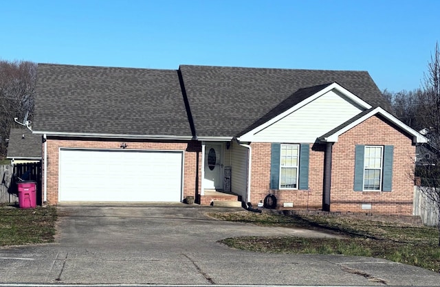 single story home featuring brick siding, fence, concrete driveway, a garage, and crawl space