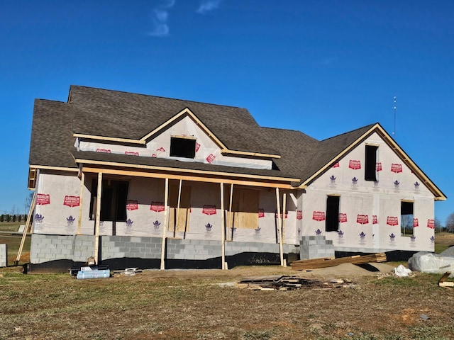 property under construction with roof with shingles