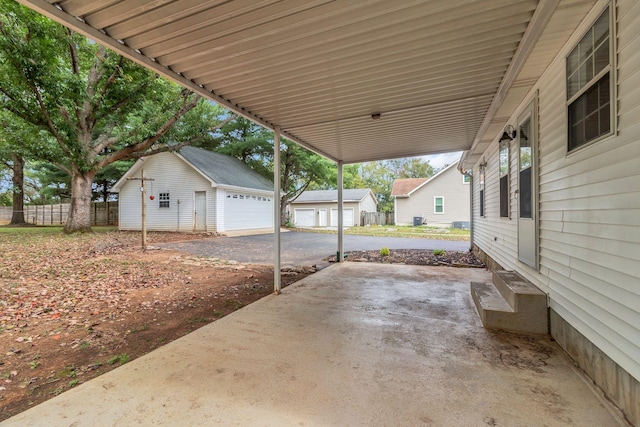 2536 Crescent Meadows Ct, Murfreesboro, TN 37128 - view of patio with a detached garage, entry steps, an outdoor structure, and fence