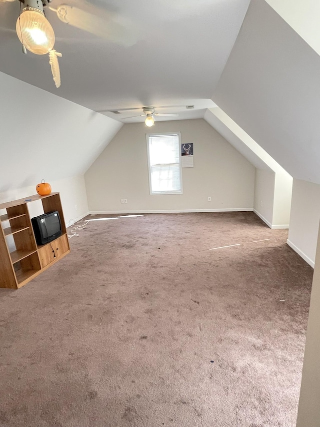 bonus room featuring vaulted ceiling, carpet flooring, a ceiling fan, and baseboards