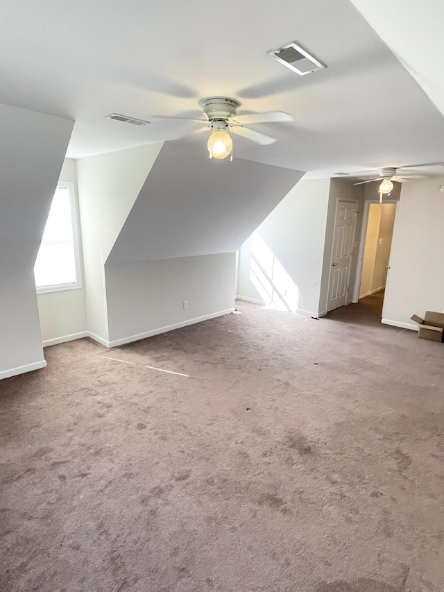 bonus room with visible vents, carpet, and ceiling fan