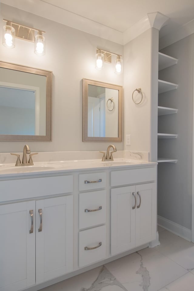 full bathroom with a sink, baseboards, marble finish floor, and double vanity