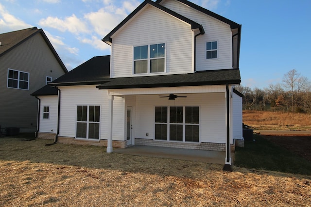 rear view of property featuring a ceiling fan and a patio