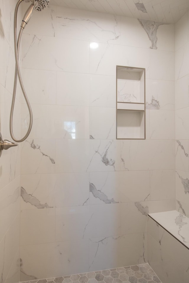 full bathroom with a tile shower