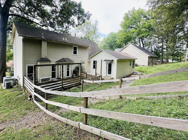 view of front of house with a deck and a front yard