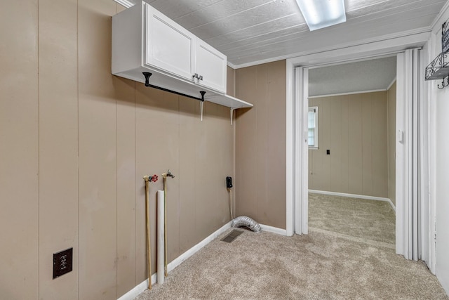 laundry area featuring visible vents, light carpet, baseboards, and laundry area