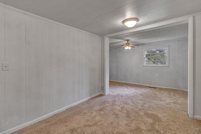 unfurnished room with visible vents, baseboards, carpet, and a ceiling fan