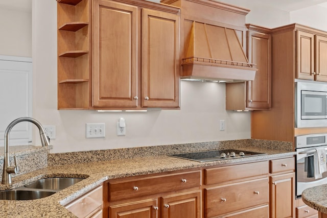 kitchen featuring premium range hood, open shelves, a sink, wall oven, and black electric cooktop