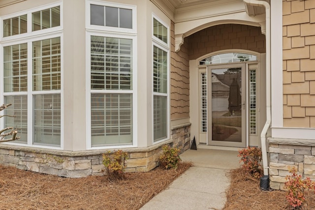 view of exterior entry featuring stone siding