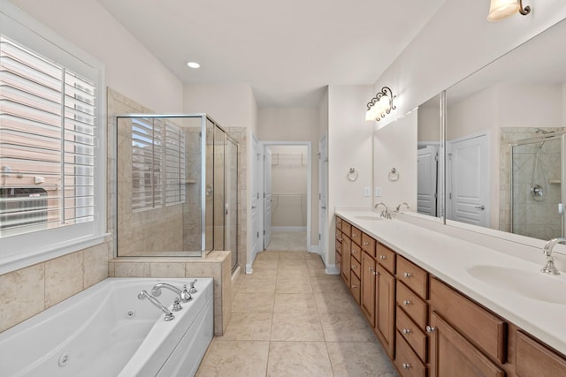 bathroom featuring a sink, double vanity, a wealth of natural light, and a shower stall