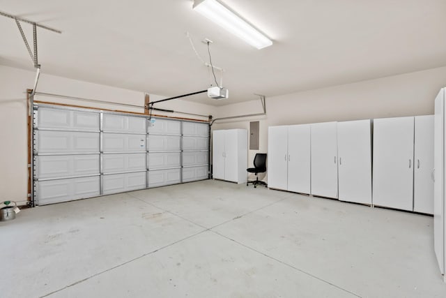 garage with electric panel and a garage door opener