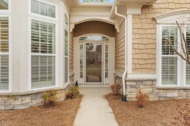 property entrance featuring stone siding