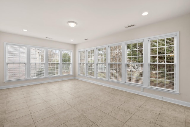 unfurnished sunroom featuring visible vents