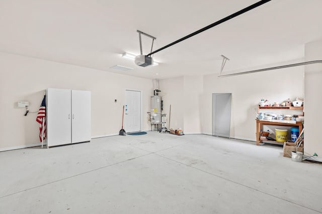 garage with water heater and a garage door opener