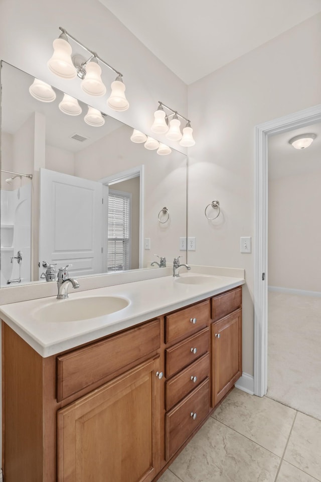 full bathroom featuring double vanity, visible vents, baseboards, and a sink