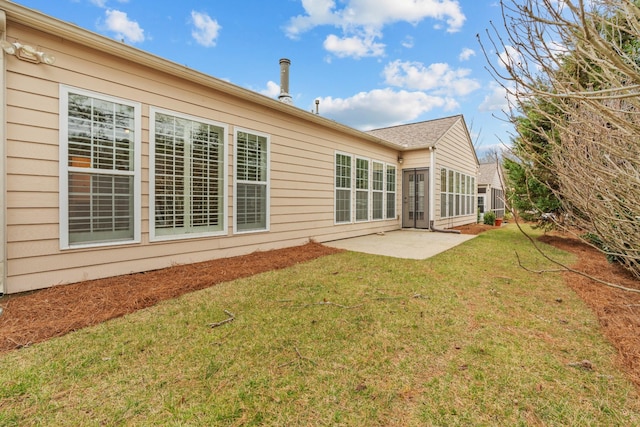 rear view of house with a patio area and a lawn