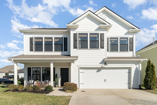 view of front of house featuring a porch, an attached garage, and driveway