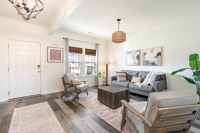 living area featuring visible vents, beam ceiling, dark wood-type flooring, baseboards, and a chandelier