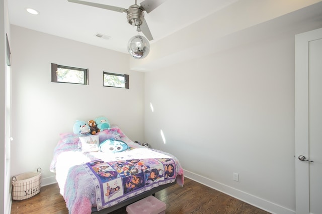 bedroom with visible vents, baseboards, and wood finished floors