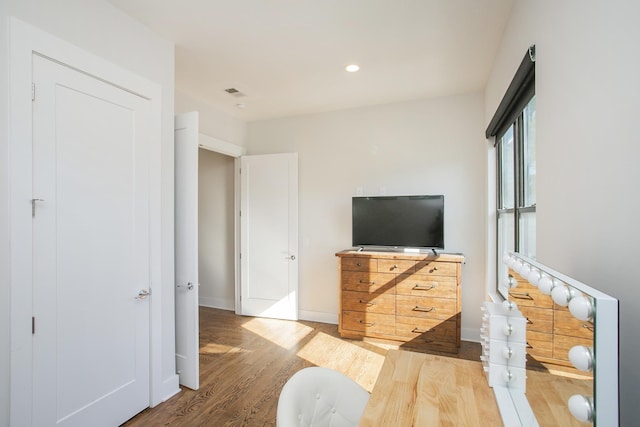 bedroom with recessed lighting, baseboards, and wood finished floors