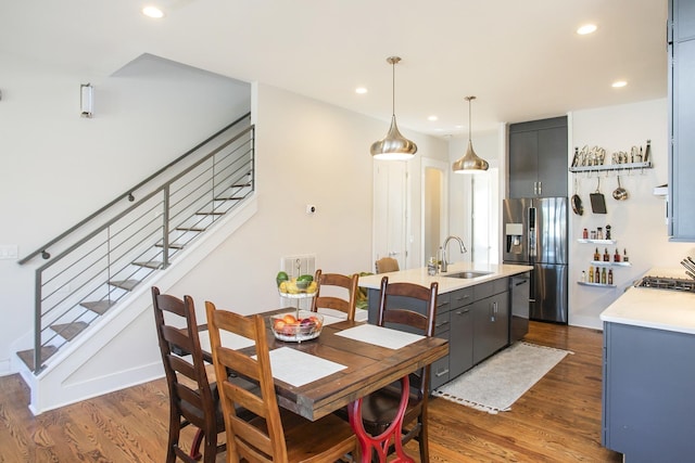 dining space featuring stairs, recessed lighting, dark wood-style flooring, and baseboards