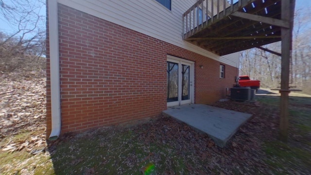 exterior space featuring cooling unit and brick siding