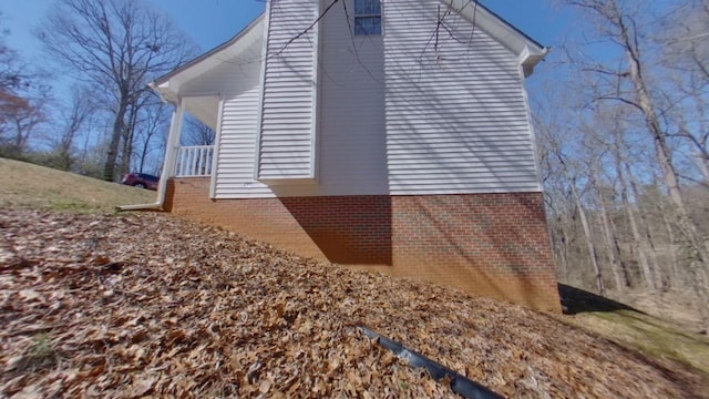 view of side of property featuring brick siding