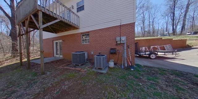 view of home's exterior with brick siding and central air condition unit