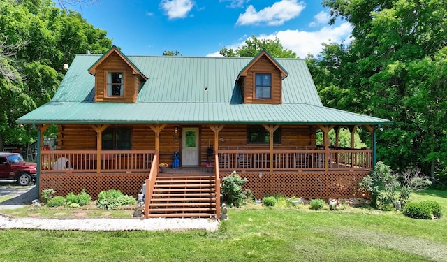 log home with metal roof, a porch, log exterior, and a front yard