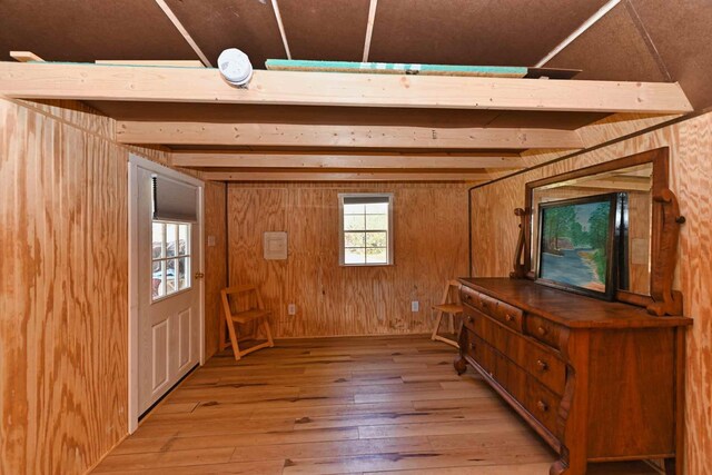 interior space with wooden walls and light wood-style flooring