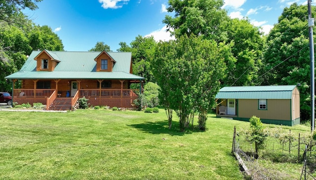 exterior space featuring a porch, log exterior, a lawn, and metal roof