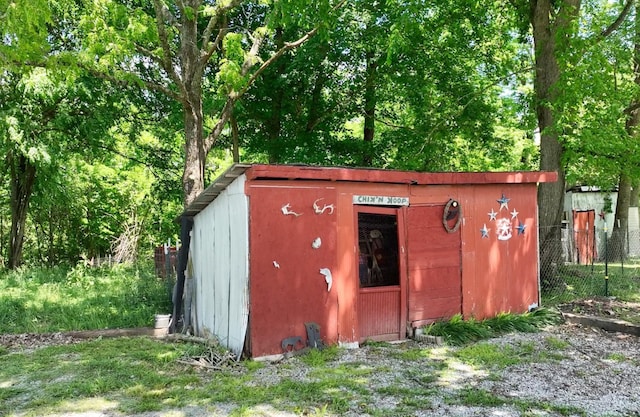 view of shed featuring fence