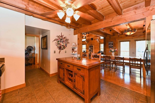 kitchen featuring beam ceiling, butcher block countertops, french doors, wooden ceiling, and brown cabinets