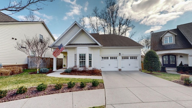 view of front of house featuring fence, concrete driveway, a front yard, a shingled roof, and a garage