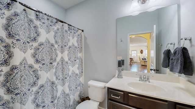 ensuite bathroom featuring toilet, vanity, and connected bathroom