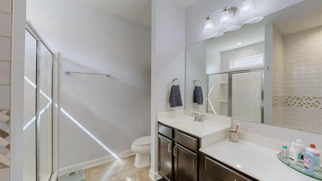 bathroom featuring vanity, toilet, a shower stall, and tile patterned flooring