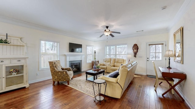 living area with a fireplace with flush hearth, dark wood finished floors, and crown molding