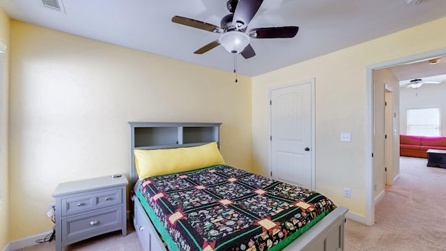 bedroom with a ceiling fan, light colored carpet, visible vents, and baseboards