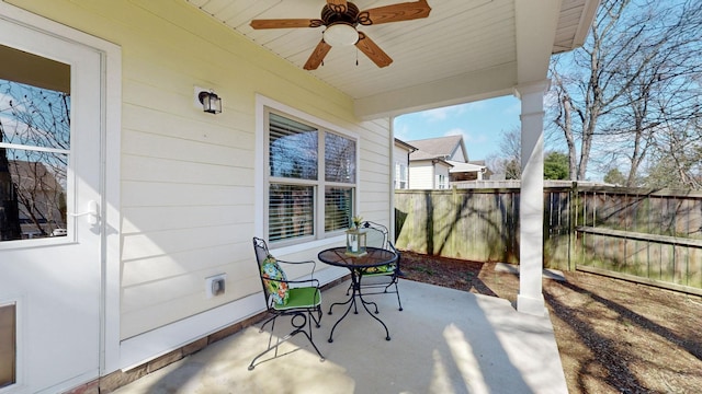 view of patio featuring a ceiling fan and fence