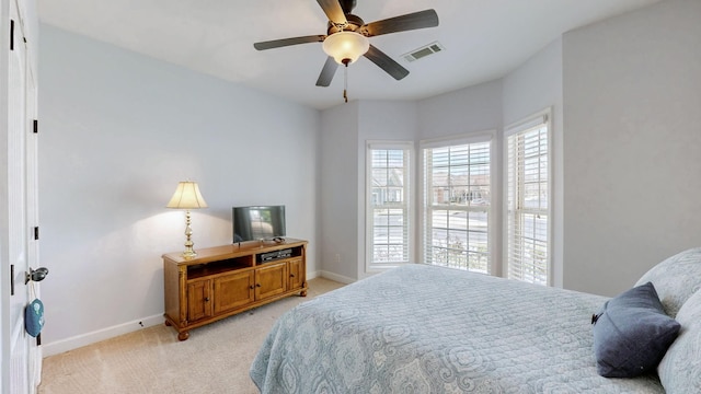 bedroom featuring light carpet, visible vents, a ceiling fan, and baseboards