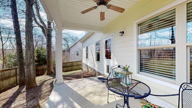 view of patio featuring a ceiling fan and fence