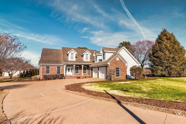 cape cod house featuring brick siding, a garage, driveway, and a front yard