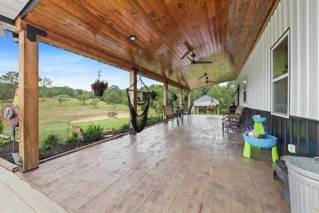 view of patio with outdoor dining area and ceiling fan