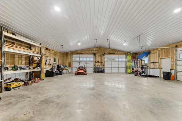 garage featuring a workshop area and metal wall