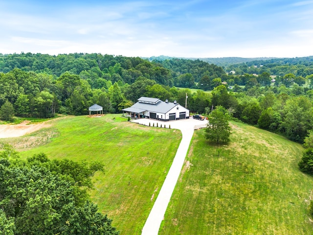 birds eye view of property featuring a view of trees