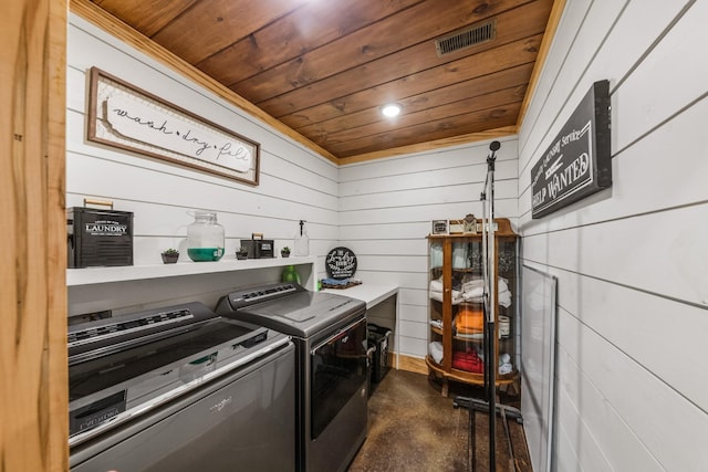 washroom with laundry area, wood ceiling, washing machine and dryer, and visible vents